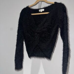 Cropped fuzzy low v-neck . Crisscross front with not detail.